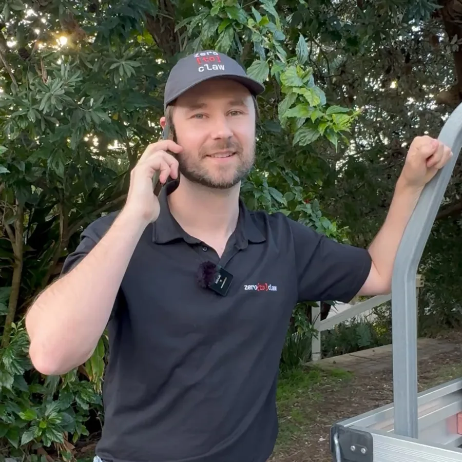 Jake from ZeroToClaw, on a job site taking a call